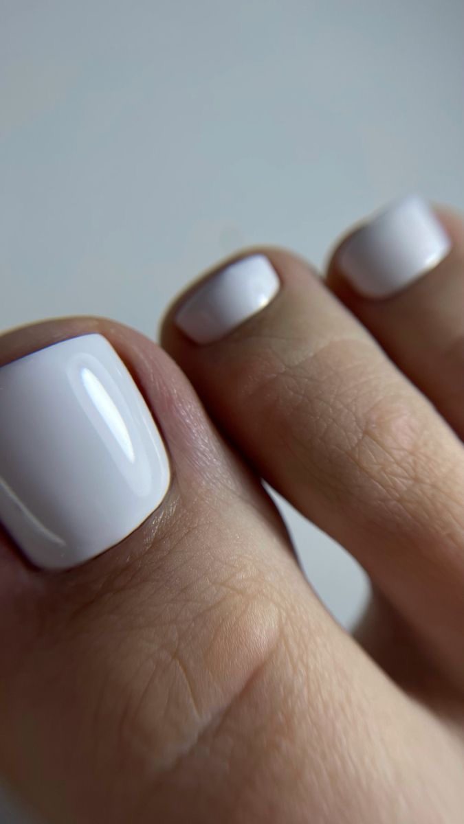 Glossy white gel pedicure at LUV Beauty Club Miami