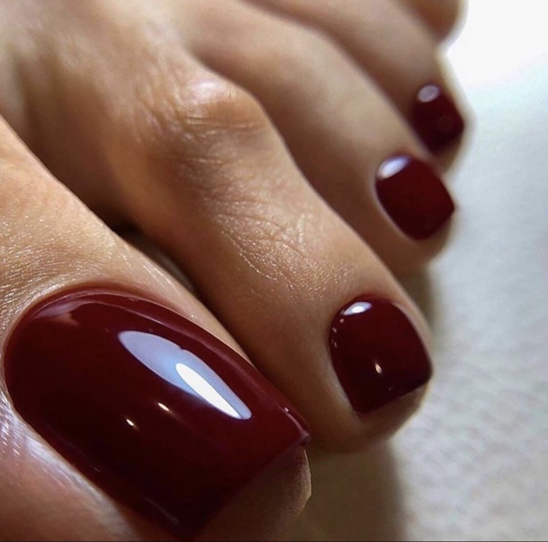 Deep burgundy gel pedicure at LUV Beauty Club Miami