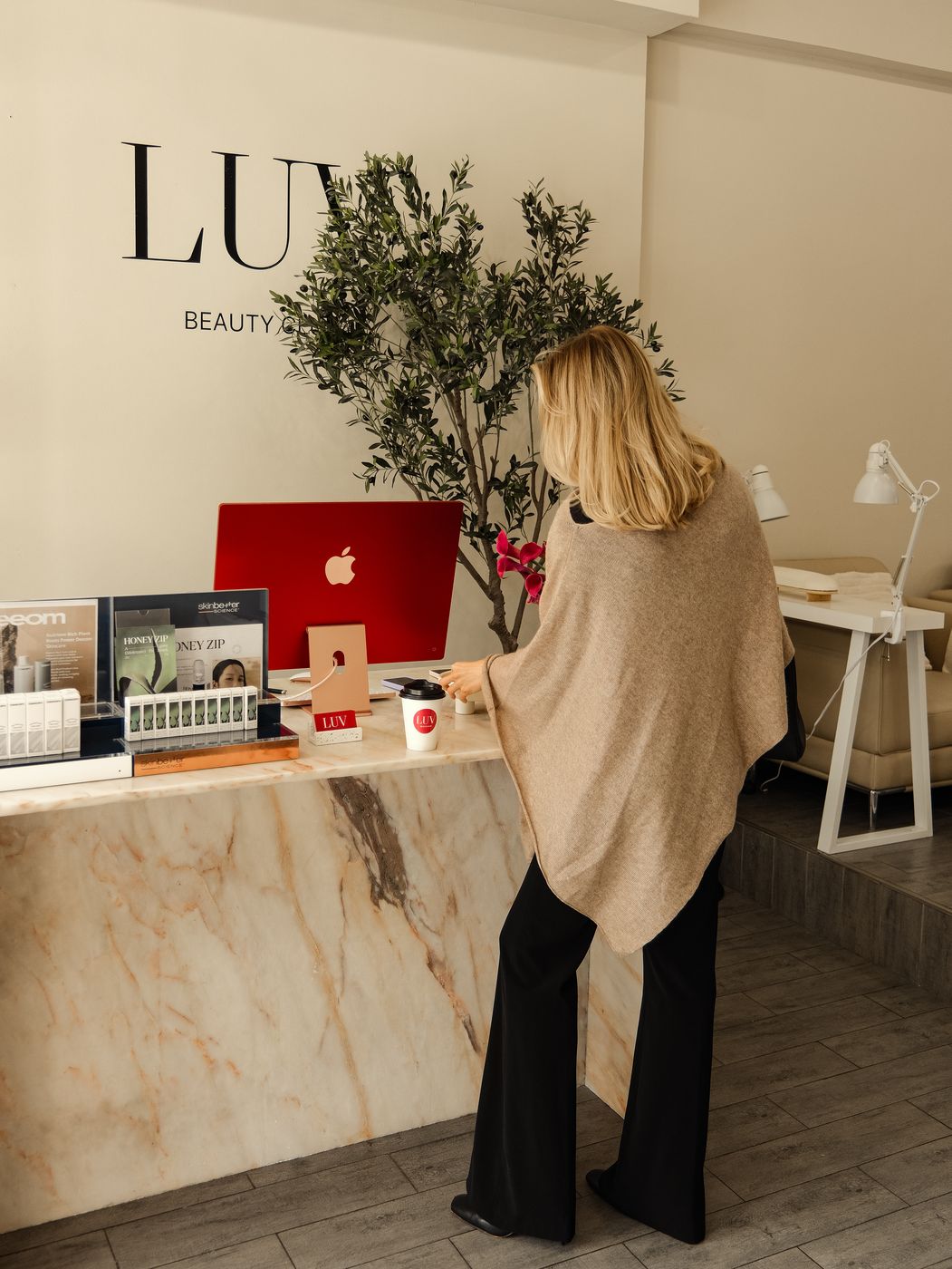 Marble reception desk and retail display at LUV Beauty Club Miami