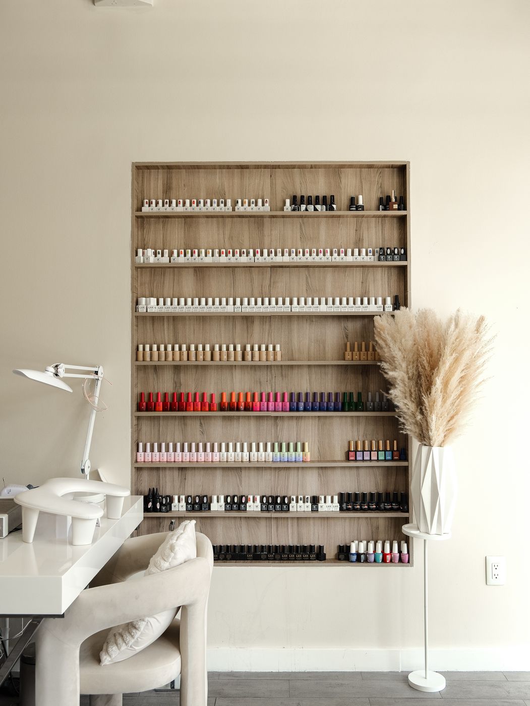 Nail polish wall and manicure station at LUV Beauty Club Miami
